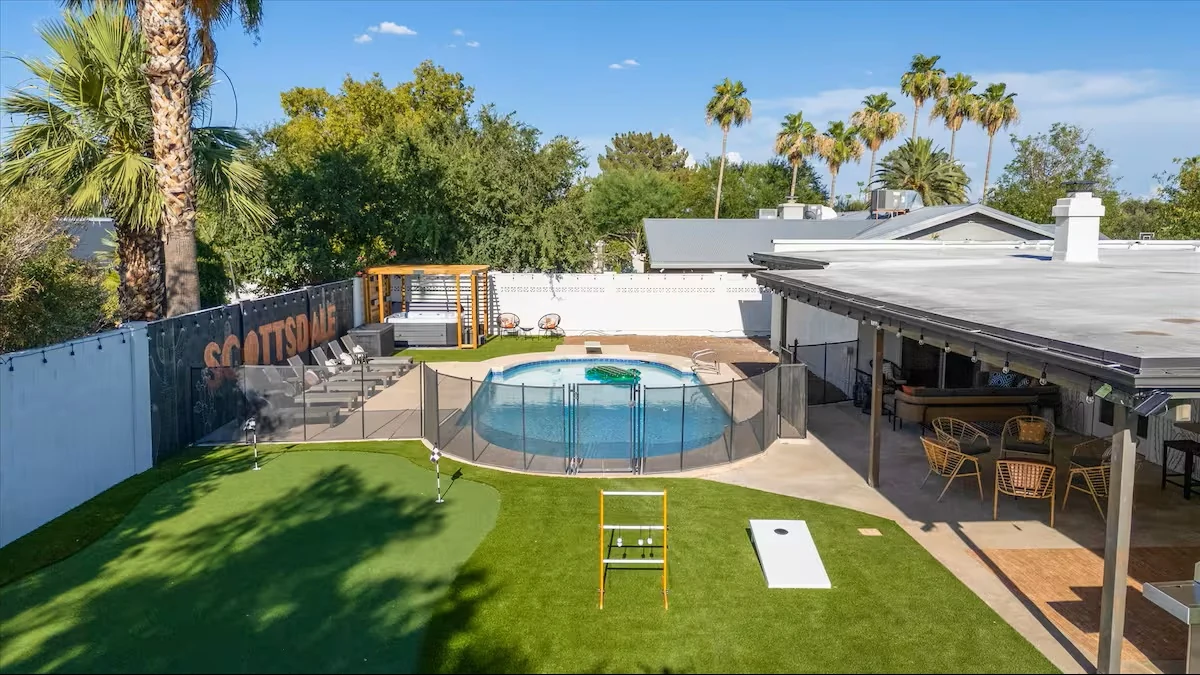 Backyard with putting green, lawn games and pool