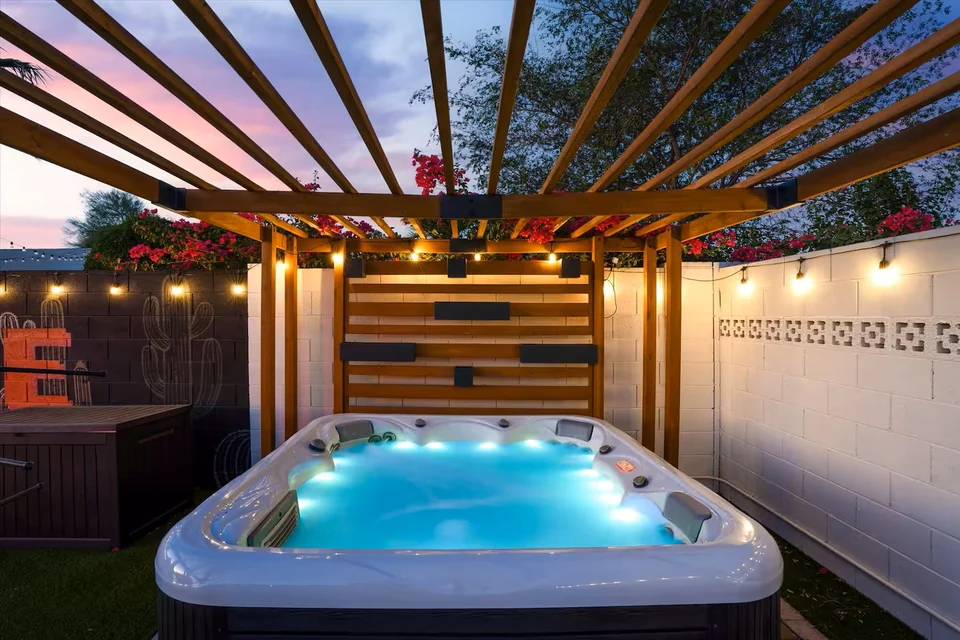 Private hot tub under a pergola with string lights at dusk — The Sunkiss, Scottsdale, Arizona