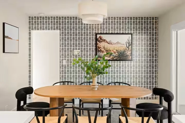 Dining room with oval table and desert artwork — The Sunkiss, Scottsdale, Arizona