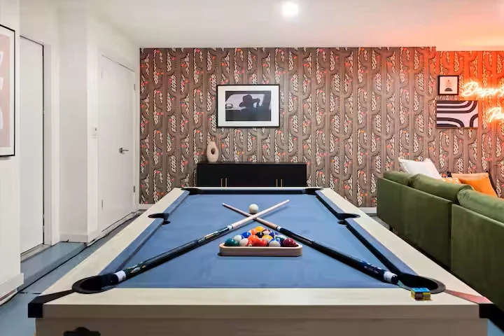 Game room with pool table and retro wallpaper