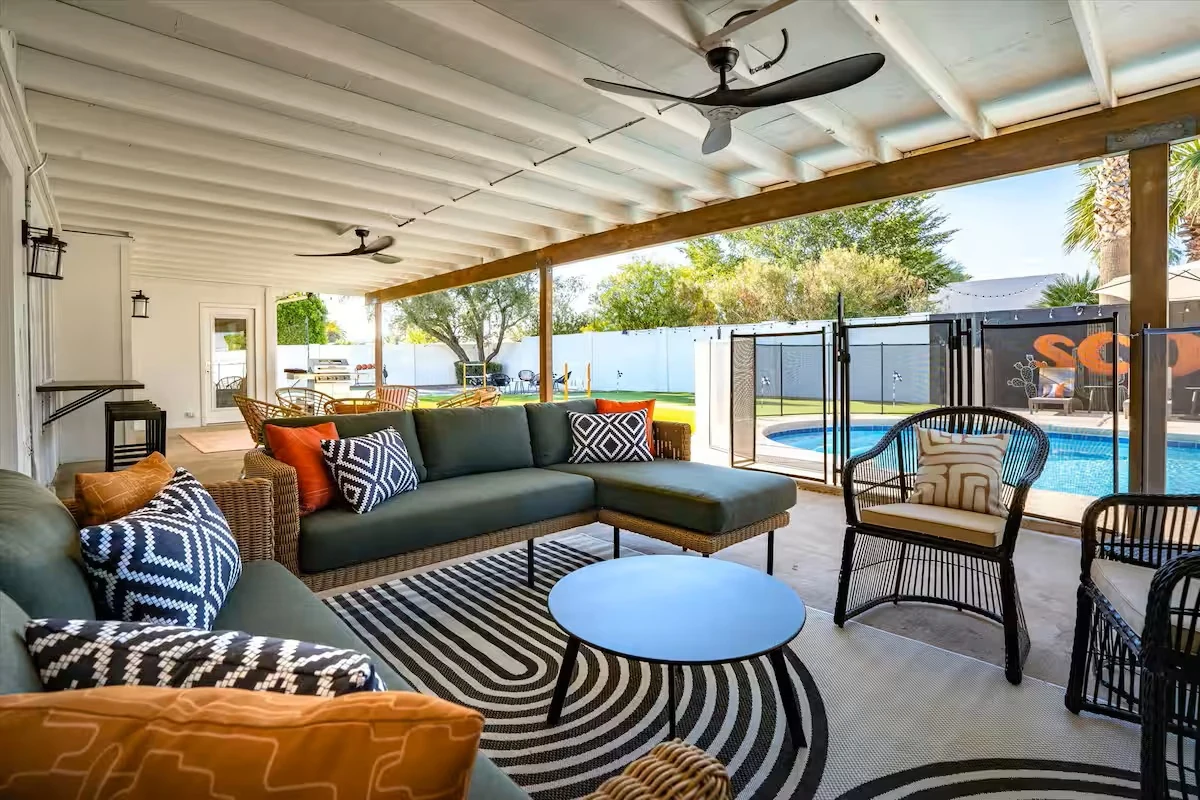 Covered patio lounge with sectional seating by the pool