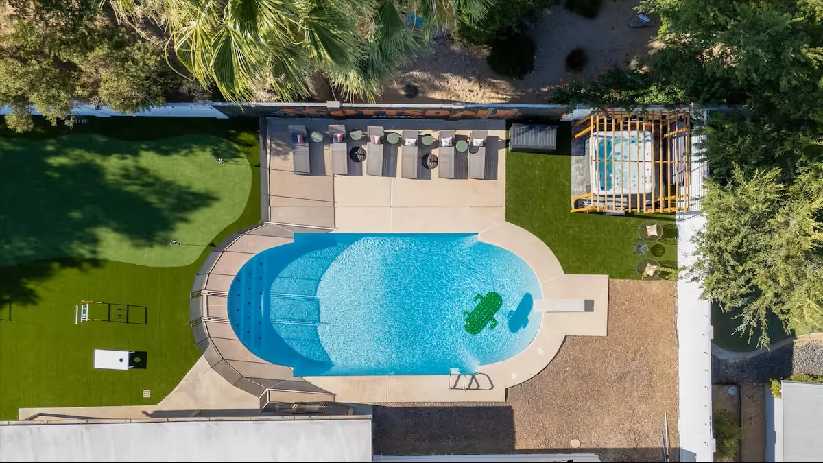 Overhead daytime view of the pool, putting green and hot tub